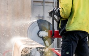 Worker cutting concrete